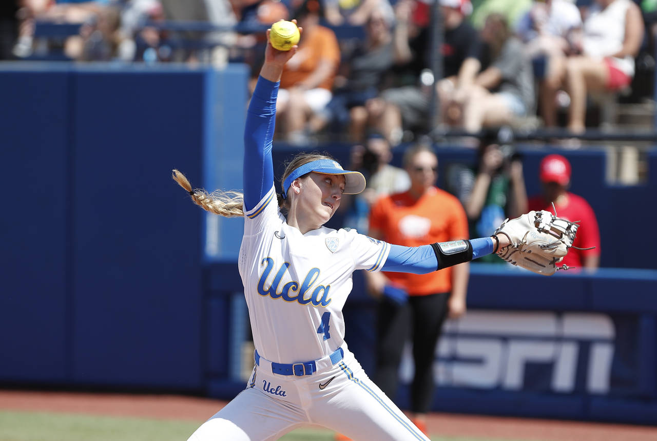 UCLA's Holly Azevedo (4) pitches in the fifth inning of an NCAA softball Women's College World Seri...