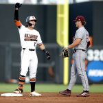 
              Oklahoma State's Marcus Brown (19) celebrates a double next to Missouri State's Mason Greer (26) during the second inning of an NCAA college baseball tournament regional game in Stillwater, Okla., Friday, June 3, 2022. (Sarah Phipps/The Oklahoman via AP)
            