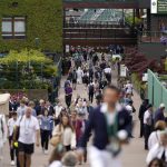 
              Spectators arrive at the courts on day one of the Wimbledon tennis championships in London, Monday, June 27, 2022. (AP Photo/Alberto Pezzali)
            