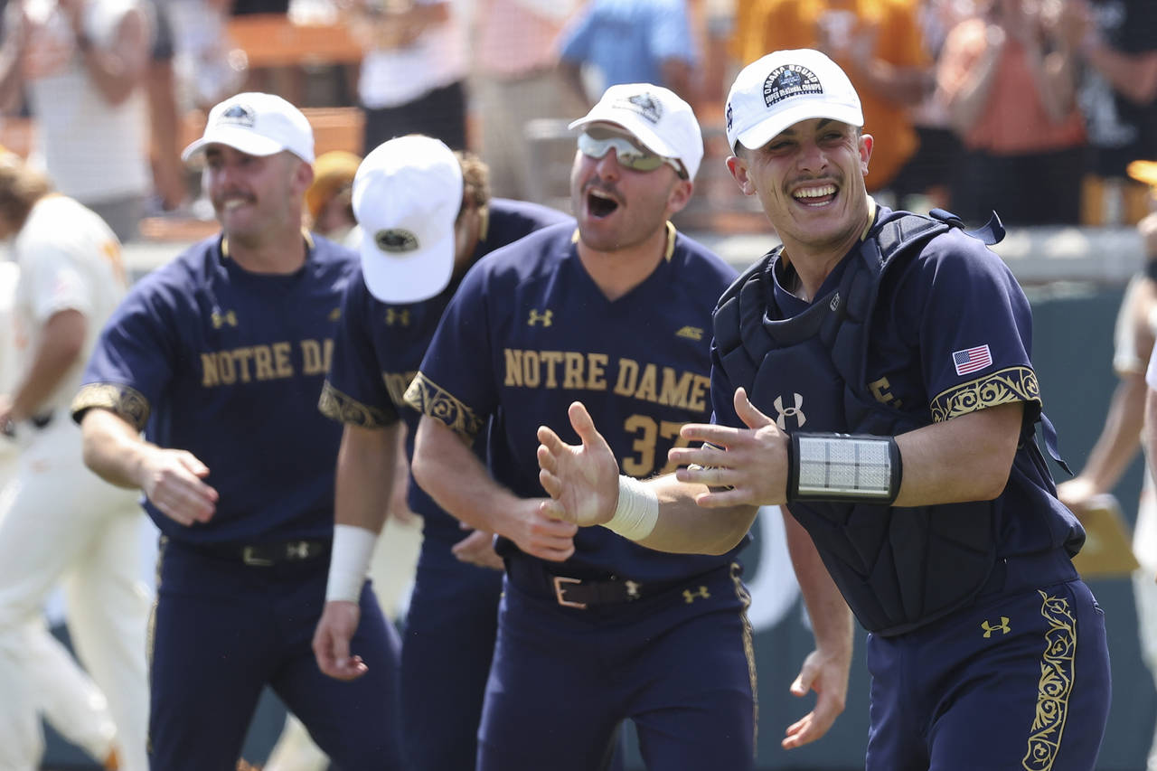 Notre Dame catcher David LaManna, right, celebrates with teammates after defeating Tennessee in an ...
