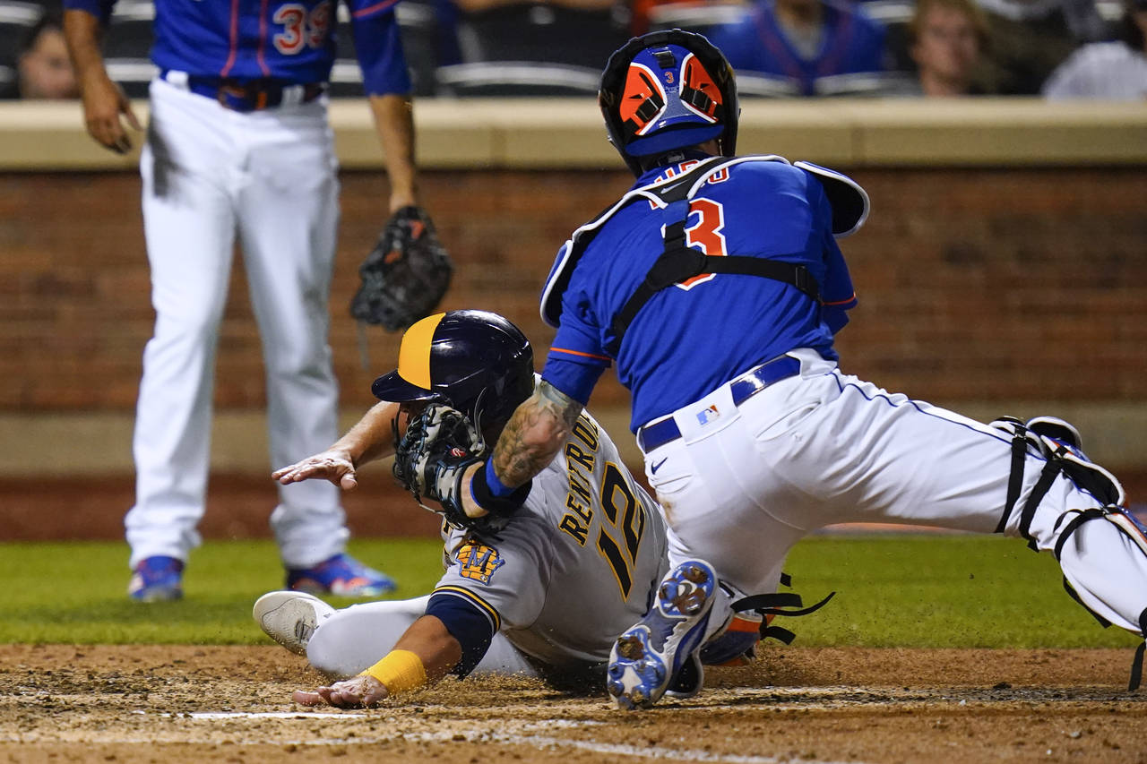 New York Mets catcher Tomas Nido (3) tags out Milwaukee Brewers' Hunter Renfroe during the ninth in...