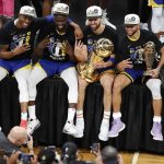 
              Golden State Warriors players pose for photos with the Larry O'Brien Trophy after defeating the Boston Celtics in Game 6 of basketball's NBA Finals, Thursday, June 16, 2022, in Boston. (AP Photo/Michael Dwyer)
            