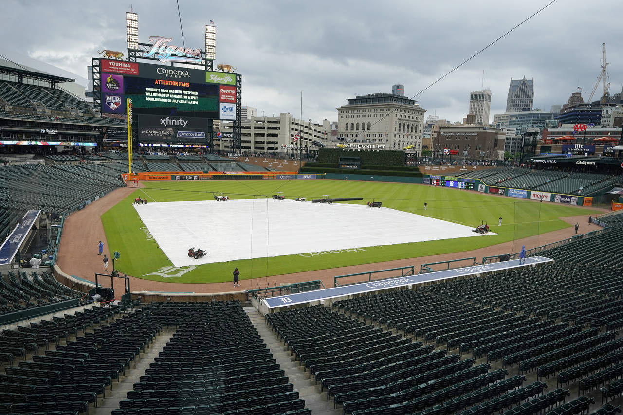 The Comerica Park infield is covered prior to the baseball game between the Detroit Tigers and the ...