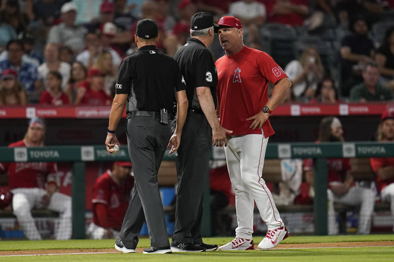Los Angeles Angels interim manager Phil Nevin (88) argues a strike call with umpire Bill Welke (3) ...
