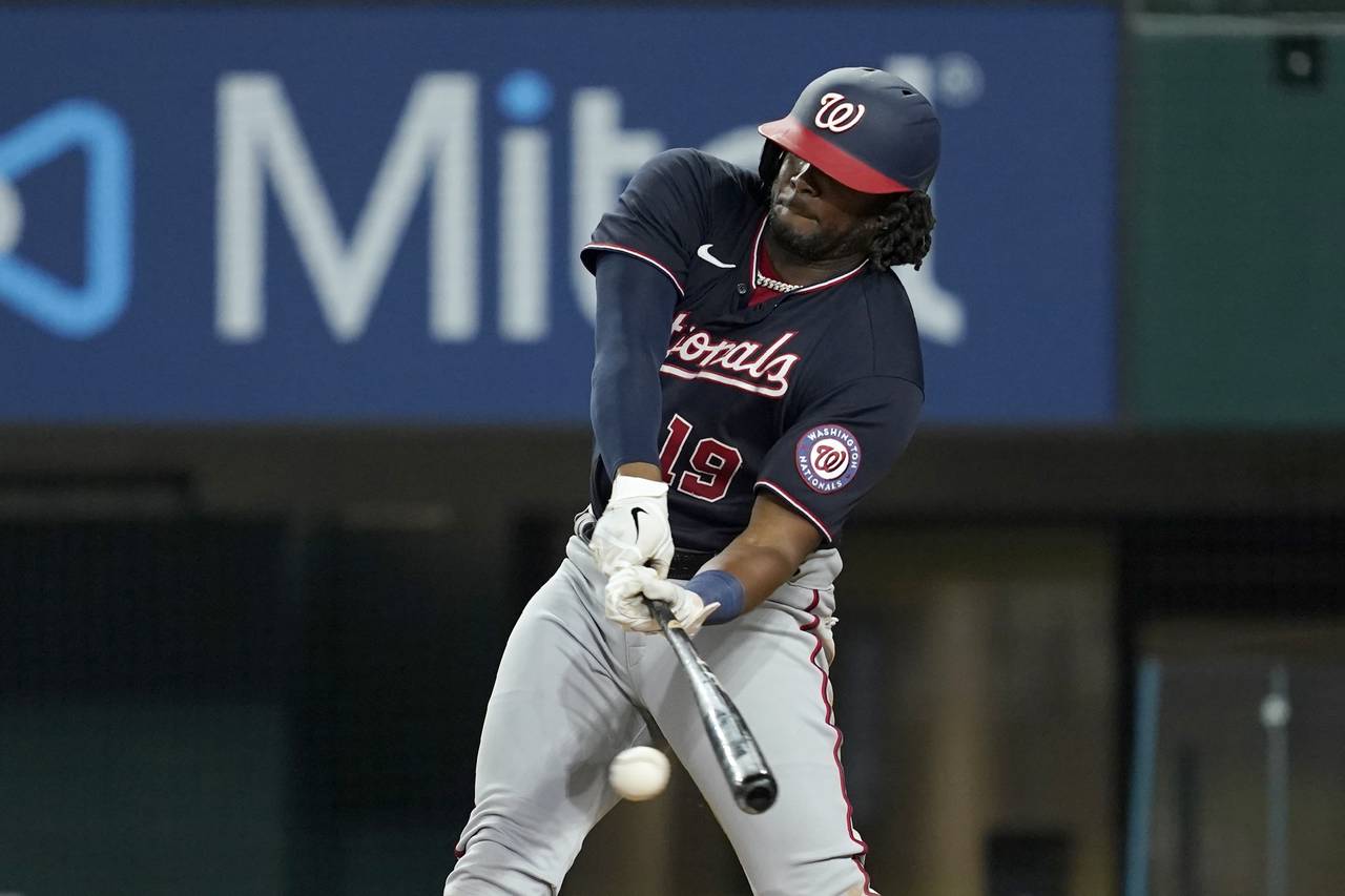 Washington Nationals' Josh Bell connects for a run-scoring single in the eighth inning of a basebal...