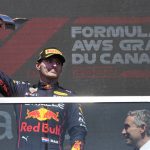 
              Red Bull Racing's Max Verstappen, left, of the Netherlands, celebrates after winning the Canadian Grand Prix auto race Sunday, June 19, 2022, in Montreal. (Ryan Remiorz/The Canadian Press via AP)
            