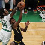 
              Boston Celtics center Robert Williams III (44) blocks a shot by Golden State Warriors forward Andrew Wiggins (22) during the third quarter of Game 4 of basketball's NBA Finals, Friday, June 10, 2022, in Boston. (AP Photo/Michael Dwyer)
            