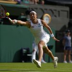 
              France's Caroline Garcia returns the ball to Britain's Emma Raducanu during their singles tennis match against on day three of the Wimbledon tennis championships in London, Wednesday, June 29, 2022. (AP Photo/Alastair Grant)
            