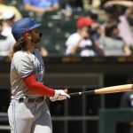 
              Toronto Blue Jays' Bo Bichette watches his grand slam home run during the fourth inning of a baseball game against the Chicago White Sox, Wednesday, June 22, 2022, in Chicago. (AP Photo/Paul Beaty)
            