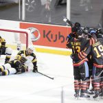
              Members of the Saint John Sea Dogs celebrate a goal by teammate Raivis Kristians Ansons in front of Hamilton Bulldogs' Gavin White, left, and teammate Mark Duarte during the first period of a Memorial Cup hockey game in Saint John, Canada, on Monday, June 20, 2022. (Darren Calabrese/The Canadian Press via AP)
            