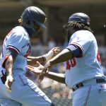 
              Minnesota Twins' Nick Gordon, left, celebrates with third base coach Tommy Watkins after hitting a solo home run against Cleveland Guardians pitcher Zach Plesac during the third inning of a baseball game, Thursday, June 23, 2022, in Minneapolis. (AP Photo/Craig Lassig)
            