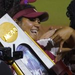 
              Oklahoma's Jocelyn Alo holds the trophy after Oklahoma defeated Texas in the NCAA softball Women's College World Series finals Thursday, June 9, 2022, in Oklahoma City. (AP Photo/Sue Ogrocki)
            