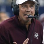 
              FILE - In this Sept. 28, 2019, file photo, Texas A&M head coach Jimbo Fisher talks with his team during the first half of an NCAA college football game against Arkansas, in Arlington, Texas. The Southeastern Conference spring meetings will be held in person for the first time since 2019 in a little less than two weeks. It is unlikely two of the league's superstar coaches will be chumming around Destin, Florida, together. (AP Photo/Ron Jenkins, File)
            