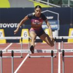 
              Sydney McLaughlin, center, clears the last hurdle on her way to setting a new world record in the women's 400 meter hurdles at the U.S. outdoor track and field championships, Saturday, June 25, 2022, in Eugene, Ore. (Chris Pietsch/The Register-Guard via AP)
            