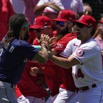 
              Seattle Mariners' J.P. Crawford, left, and several members of the Los Angeles Angels scuffle after Mariners' Jesse Winker was hit by a pitch during the second inning of a baseball game Sunday, June 26, 2022, in Anaheim, Calif. (AP Photo/Mark J. Terrill)
            