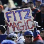 
              FILE - A Buffalo Bills fans holds up a sign in support of Bills quarterback Ryan Fitzpatrick during the first half of an NFL football game against the Tennessee Titans in Orchard Park, N.Y., Sunday, Oct. 21, 2012. Quarterback Ryan Fitzpatrick confirmed to The Associated Press on Friday, June 3, 2022, that he informed former teammates of his intention to retire a day earlier. (AP Photo/Gary Wiepert, File)
            