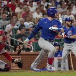
              Chicago Cubs' Ian Happ hits an RBI double during the fifth inning of a baseball game against the St. Louis Cardinals Friday, June 24, 2022, in St. Louis. (AP Photo/Jeff Roberson)
            