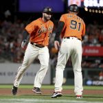 
              San Francisco Giants' Darin Ruf, left, is congratulated by third base coach Mark Hallberg (91) after hitting a home run against the Los Angeles Dodgers during the eighth inning of a baseball game in San Francisco, Friday, June 10, 2022. (AP Photo/Jed Jacobsohn)
            