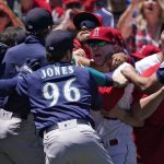 
              Several members of the Seattle Mariners and the Los Angeles Angels scuffle after Mariners' Jesse Winker was hit by a pitch during the second inning of a baseball game Sunday, June 26, 2022, in Anaheim, Calif. (AP Photo/Mark J. Terrill)
            