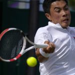 
              Brandon Nakashima of the US returns to Canada's Denis Shapovalov in a second round men's single match on day four of the Wimbledon tennis championships in London, Thursday, June 30, 2022. (AP Photo/Alastair Grant)
            