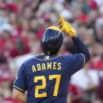 
              Milwaukee Brewers' Willy Adames (27) scores after hitting a solo home run during the fifth inning of the team's baseball game against the Cincinnati Reds, Friday, June 17, 2022, in Cincinnati. (AP Photo/Jeff Dean)
            