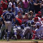 
              Several members of the Seattle Mariners and the Los Angeles Angels scuffle after Mariners' Jesse Winker was hit by a pitch during the second inning of a baseball game Sunday, June 26, 2022, in Anaheim, Calif. (AP Photo/Mark J. Terrill)
            