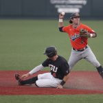
              Auburn infielder Brody Moore, right, throws to first base after putting out Oregon State's Justin Boyd, left, on a fielder's choice during the first inning of an NCAA college baseball tournament super regional game on Monday, June 13, 2022, in Corvallis, Ore. (AP Photo/Amanda Loman)
            