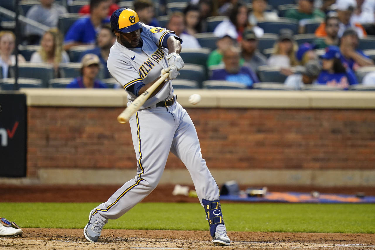 Milwaukee Brewers' Lorenzo Cain hits a single during the fourth inning of a baseball game against t...