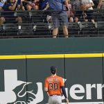 
              Houston Astros right fielder Kyle Tucker (30) watches fans reach for a solo home run hit by Texas Rangers' Marcus Semien during the third inning of a baseball game in Arlington, Texas, Wednesday, June 15, 2022. (AP Photo/LM Otero)
            