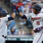 
              Minnesota Twins' Jorge Polanco (11) celebrates with Luis Arraez (2) after hitting a two-run home run against the Cleveland Guardians during the third inning in the second baseball game of a doubleheader Tuesday, June 28, 2022, in Cleveland. (AP Photo/Ron Schwane)
            
