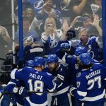 
              Teammates surround and congratulated Tampa Bay Lightning center Steven Stamkos (91) after his goal during the first period of Game 6 of the NHL hockey Stanley Cup Finals against the Colorado Avalanche on Sunday, June 26, 2022, in Tampa, Fla. (AP Photo/John Bazemore)
            