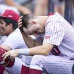
              Oklahoma's Tanner Tredaway sits in the dugout following their 4-2 loss against Mississippi in Game 2 of the NCAA College World Series baseball finals, Sunday, June 26, 2022, in Omaha, Neb. Mississippi defeated Oklahoma 4-2 to win the championship. (AP Photo/Rebecca S. Gratz)
            