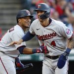 
              Minnesota Twins' Carlos Correa (4) celebrates with Jorge Polanco after scoring against the Cleveland Guardians during the third inning in the second baseball game of a doubleheader Tuesday, June 28, 2022, in Cleveland. (AP Photo/Ron Schwane)
            