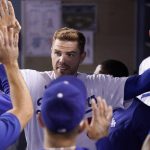 
              Los Angeles Dodgers' Freddie Freeman is congratulated by teammates in the dugout after scoring on a walk by Justin Turner during the fourth inning of a baseball game against the Los Angeles Angels Tuesday, June 14, 2022, in Los Angeles. (AP Photo/Mark J. Terrill)
            