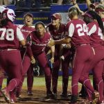 
              Oklahoma's Jocelyn Alo (78) is greeted at the plate  following her home run against Texas during the fifth inning of the first game of the NCAA Women's College World Series softball championship series Wednesday, June 8, 2022, in Oklahoma City. (AP Photo/Sue Ogrocki)
            