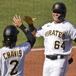 
              Pittsburgh Pirates' Diego Castillo (64) is greeted by teammate Michael Chavis as he crosses home plate after hitting a three-run home run off San Francisco Giants starting pitcher Alex Wood during the third inning of a baseball game in Pittsburgh, Saturday, June 18, 2022. (AP Photo/Gene J. Puskar)
            