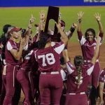 
              Oklahoma players celebrate with the trophy after defeating Texas in the NCAA Women's College World Series softball finals Thursday, June 9, 2022, in Oklahoma City. (AP Photo/Sue Ogrocki)
            