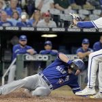 
              Toronto Blue Jays' Bradley Zimmer slides home to score on a wild pitch by Kansas City Royals relief pitcher Dylan Coleman during the seventh inning of a baseball game Tuesday, June 7, 2022, in Kansas City, Mo. (AP Photo/Charlie Riedel)
            