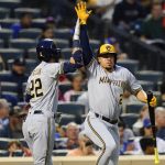 
              Milwaukee Brewers' Christian Yelich (22) celebrates with Willy Adames, right, after hitting a home run during the fourth inning of the team's baseball game against the New York Mets on Thursday, June 16, 2022, in New York. (AP Photo/Frank Franklin II)
            