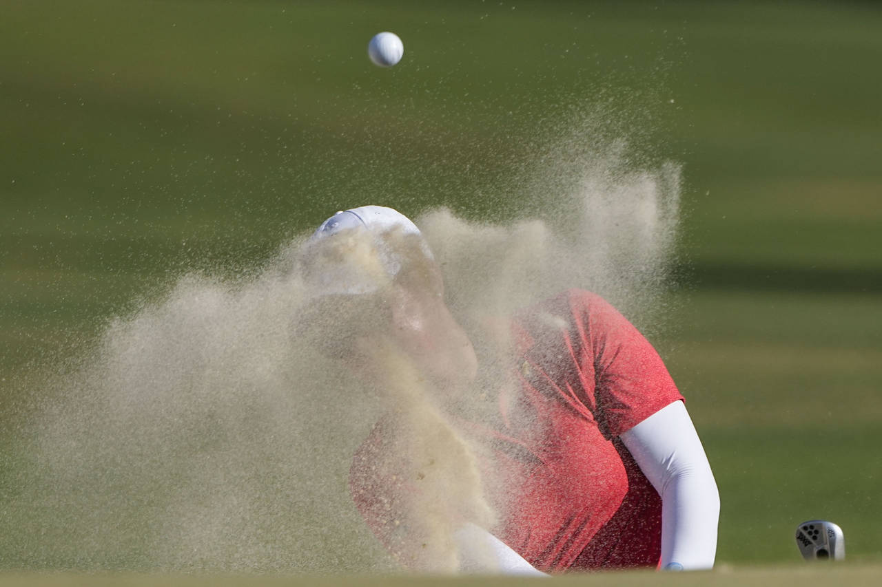 Mina Harigae hits out of a bunker on the 14th hole during the final round of the U.S. Women's Open ...