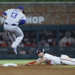 
              Atlanta Braves' Matt Olson is safe at second, sliding in under Los Angeles Dodgers' Max Muncy during the tenth inning of a baseball game won by the Los Angeles Dodgers 5-3 on Sunday, June 26, 2022, in Atlanta. (AP Photo/Bob Andres)
            