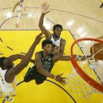 
              Boston Celtics guard Marcus Smart, middle, shoots against Golden State Warriors forward Draymond Green, bottom, and forward Andrew Wiggins during the second half of Game 5 of basketball's NBA Finals in San Francisco, Monday, June 13, 2022. (AP Photo/Jed Jacobsohn, Pool)
            