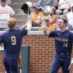 
              Notre Dame's Jack Brannigan (9) is congratulated by Zack Prajzner (14) after hitting a solo home run against Tennessee in the seventh inning of an NCAA college baseball super regional game Sunday, June 12, 2022, in Knoxville, Tenn. (AP Photo/Randy Sartin)
            