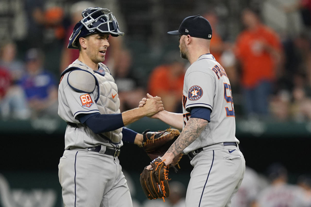 Houston Astros closer Ryan Pressly (55) is congratulated by catcher Jason Castro after the team's w...