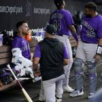 
              Colorado Rockies starting pitcher Chad Kuhl, left, talks with pitching coach Darryl Scott, center, and catcher Elias Diaz (35) during the fourth inning of a baseball game against the Miami Marlins, Wednesday, June 22, 2022, in Miami. (AP Photo/Lynne Sladky)
            
