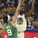 
              Golden State Warriors forward Andrew Wiggins (22) shoots against Boston Celtics guard Derrick White (9) during the first half of Game 1 of basketball's NBA Finals in San Francisco, Thursday, June 2, 2022. (AP Photo/Jed Jacobsohn)
            