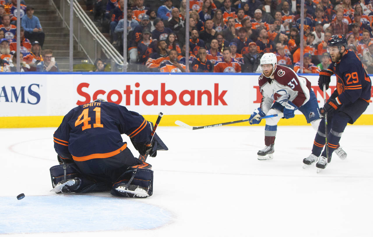 Colorado Avalanche left wing J.T. Compher (37) scores on Edmonton Oilers goalie Mike Smith (41) as ...