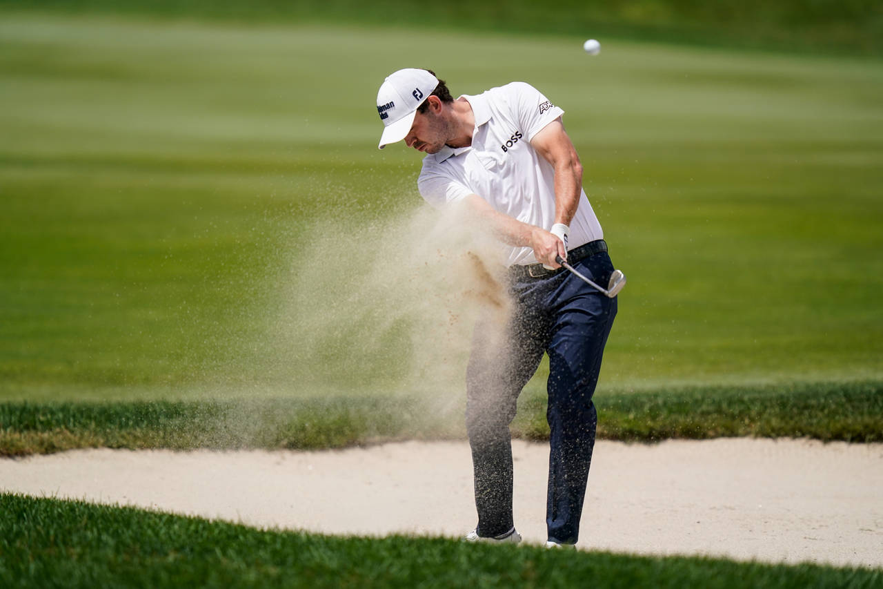 Patrick Cantlay shoots out of the bunker on the ninth hole during the second round of the Travelers...