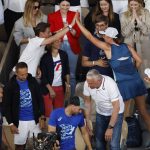 
              Poland's Iga Swiatek goes in the players box to celebrate with relative her victory over Coco Gauff of the U.S. during their final match of the French Open tennis tournament at the Roland Garros stadium Saturday, June 4, 2022 in Paris. Swiatek won 6-1, 6-3. (AP Photo/Jean-Francois Badias)
            