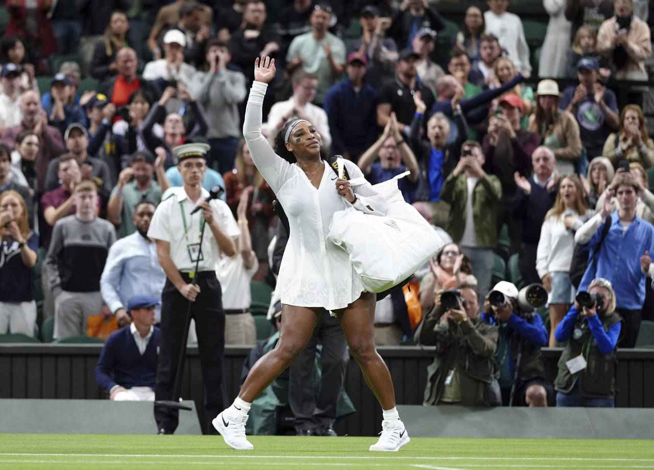 Serena Williams of the US waves as she leaves the court after losing to France's Harmony Tan in a f...